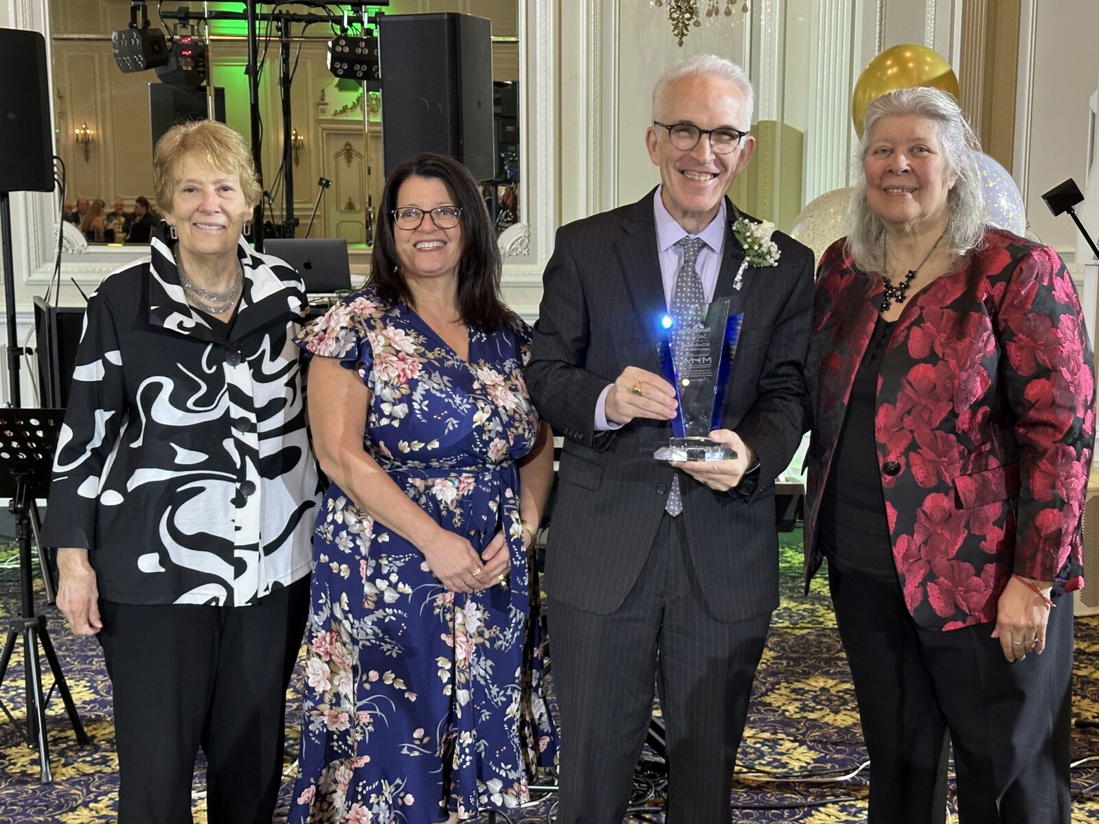 Barbara Small, MHA Board President, Nadine Venezia, MHA Chief Operating Officer, Robert Davison, MHA CEO, and NewBridge CEO post for a photo at the Legacy of Hope Gala