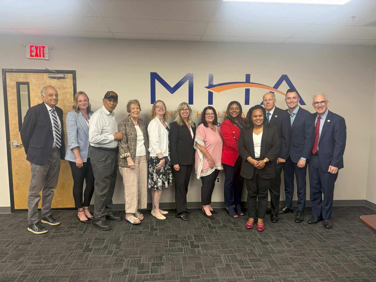 MHA's senior leadership posing for a photo with Deputy Commissioner of Veterans Affairs Esther Chucaralao and Chief of Staff Dillon Chorba, along with Morris County leadership, including the Morris County Commissioner John Krickus and representatives from the Morris County Government